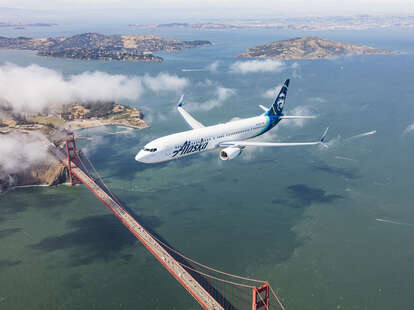 Alaska Airlines plane flies over the Golden Gate bridge in San Francisco
