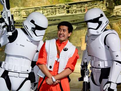 Frightened man surrounded by Stormtroopers at Disney World